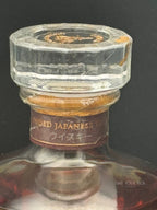 Vintage Japanese whisky bottle neck with aged label and glass stopper, showcasing premium liquor details.